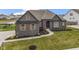 Inviting single-Gathering home featuring a lush lawn and meticulously landscaped yard at 18271 Lake Winds Dr, Westfield, IN 46074