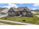 Charming single-Gathering home with a beautifully landscaped yard and a view of a pond at 18271 Lake Winds Dr, Westfield, IN 46074