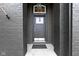 Modern gray front door with black brick and stylish hardware at 18271 Lake Winds Dr, Westfield, IN 46074