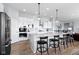 Modern kitchen with white cabinets, a large island with seating, and stainless steel appliances at 18271 Lake Winds Dr, Westfield, IN 46074