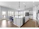 Open-concept kitchen with a large island, stainless steel appliances, and adjacent dining area at 18271 Lake Winds Dr, Westfield, IN 46074