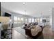 Open-concept living room with ample natural light, hardwood floors, and comfortable seating at 18271 Lake Winds Dr, Westfield, IN 46074