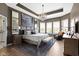 Luxurious main bedroom with elegant lighting, a decorative tray ceiling, and ample natural light at 18271 Lake Winds Dr, Westfield, IN 46074