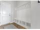 A well-organized mudroom with storage and seating offers convenience and style with a clean, bright design at 18271 Lake Winds Dr, Westfield, IN 46074