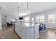 Bright and airy open concept kitchen and living area with modern decor and finishes at 18271 Lake Winds Dr, Westfield, IN 46074