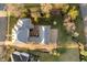 This aerial view shows the rear patio and basketball court along with the neighborhood at 1997 Finchley Rd, Carmel, IN 46032