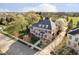 Stunning aerial view of a brick home with mature trees and manicured lawn in a desirable neighborhood at 1997 Finchley Rd, Carmel, IN 46032