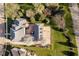 A stunning home features a brick patio, lush lawn, beautiful landscaping, and a basketball court at 1997 Finchley Rd, Carmel, IN 46032