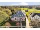 Beautiful aerial view of brick home with meticulously manicured lawn and mature trees at 1997 Finchley Rd, Carmel, IN 46032