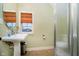Bathroom featuring pedestal sink, framed mirror, and tiled floors at 1997 Finchley Rd, Carmel, IN 46032