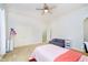 Bedroom showcasing a twin bed, a plush sofa, and a ceiling fan at 1997 Finchley Rd, Carmel, IN 46032