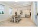Open dining area with access to kitchen, featuring modern lighting and neutral color palette at 1997 Finchley Rd, Carmel, IN 46032