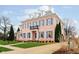 Elegant two-story home highlighting a manicured lawn and inviting front entrance with blue shutters at 1997 Finchley Rd, Carmel, IN 46032