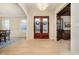 Inviting foyer showcasing gleaming hardwood floors and a stunning entryway with custom double doors at 1997 Finchley Rd, Carmel, IN 46032