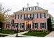 Stunning brick home with blue shutters, dormer windows, and professionally landscaped front yard at 1997 Finchley Rd, Carmel, IN 46032