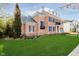 Beautiful brick home with lush green lawn and mature landscaping at 1997 Finchley Rd, Carmel, IN 46032
