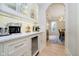 Hallway showcasing a built-in beverage center with a wine fridge and access to dining area at 1997 Finchley Rd, Carmel, IN 46032