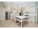 Spacious kitchen with white cabinets, large island, stainless steel appliances, and elegant chandelier at 1997 Finchley Rd, Carmel, IN 46032
