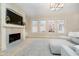 Bright living room with a fireplace, built-in shelving, large windows, and plush seating at 1997 Finchley Rd, Carmel, IN 46032