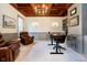 Cozy office with a coffered ceiling, built-in shelving, and a comfortable leather chair at 1997 Finchley Rd, Carmel, IN 46032