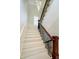 Elegant staircase with wood railing and iron spindles, illuminated by a modern chandelier at 1997 Finchley Rd, Carmel, IN 46032