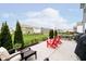 Outdoor patio with seating area, including red Adirondack chairs and a barbecue grill at 19992 Fenside Xing, Westfield, IN 46074