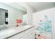 Clean bathroom features a double vanity, large mirror, and shower with decorative coral curtain at 19992 Fenside Xing, Westfield, IN 46074
