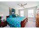 Comfortable bedroom with large bed, ceiling fan, and natural light from the two windows at 19992 Fenside Xing, Westfield, IN 46074