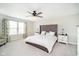 Bedroom with tufted headboard, neutral walls and carpet, natural light, and side tables at 19992 Fenside Xing, Westfield, IN 46074