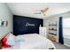 Bedroom with a modern touch has accent wall, ceiling fan, and good natural light at 19992 Fenside Xing, Westfield, IN 46074