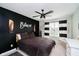 Cozy bedroom with black accent wall, baseball decor, ceiling fan, and good light at 19992 Fenside Xing, Westfield, IN 46074
