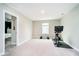 A simple bedroom featuring a Peloton exercise bike, with neutral walls and carpet at 19992 Fenside Xing, Westfield, IN 46074