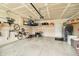 Organized garage features storage racks, bikes, lawn equipment, and white walls at 19992 Fenside Xing, Westfield, IN 46074