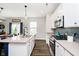 Bright kitchen showcases white cabinets, a gray countertop, stainless appliances and hardwood floor at 19992 Fenside Xing, Westfield, IN 46074