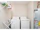 Neat laundry room with washer, dryer, shelving, and hot water heater at 19992 Fenside Xing, Westfield, IN 46074
