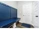 Blue mudroom bench with overhead coat rack and a door leading outside at 19992 Fenside Xing, Westfield, IN 46074