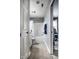 Hallway view into bathroom with tub/shower and white fixtures and a connecting bedroom at 2067 Rhettsbury St, Carmel, IN 46032
