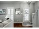 Bright entryway featuring hardwood floors, white trim, and a staircase leading to the upper level at 2067 Rhettsbury St, Carmel, IN 46032