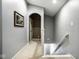Upstairs hallway features neutral paint, carpet flooring, and an arched doorway at 2067 Rhettsbury St, Carmel, IN 46032