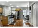 Bright eat-in kitchen features stainless steel appliances, hardwood floors, and a modern island with seating at 2067 Rhettsbury St, Carmel, IN 46032