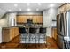 Bright, open-concept kitchen with stainless steel appliances, granite counters, an island with barstool seating at 2067 Rhettsbury St, Carmel, IN 46032