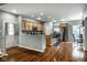 Open-concept kitchen with wood cabinets, stainless steel appliances, and bar seating overlooking the dining area at 2067 Rhettsbury St, Carmel, IN 46032