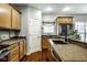 Updated kitchen featuring granite countertops, wood cabinets, stainless steel appliances, and modern fixtures at 2067 Rhettsbury St, Carmel, IN 46032