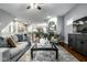 Comfortable living room featuring a fireplace, neutral decor, and seamless flow into the dining and kitchen areas at 2067 Rhettsbury St, Carmel, IN 46032