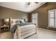 The main bedroom features vaulted ceilings, two windows, and a king bed with stylish decor at 2067 Rhettsbury St, Carmel, IN 46032