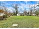Large backyard featuring green grass and minimal landscaping at 214 W Elbert St, Indianapolis, IN 46217