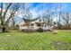 View of the home's white exterior and the raised deck, with expansive backyard at 214 W Elbert St, Indianapolis, IN 46217