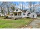 Backyard view of white home featuring a large deck and landscaped yard at 214 W Elbert St, Indianapolis, IN 46217