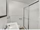 A stylish bathroom featuring a sink and shower with glass doors, offering a clean aesthetic at 214 W Elbert St, Indianapolis, IN 46217