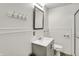 A stylish bathroom with a modern vanity, framed mirror, and shower with glass doors at 214 W Elbert St, Indianapolis, IN 46217